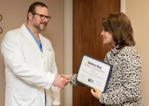 Dr. Victor Pilewski, MD FACS shaking hands with Janet Thompson, Membership Liason with the Pennsylvania Medical Society.