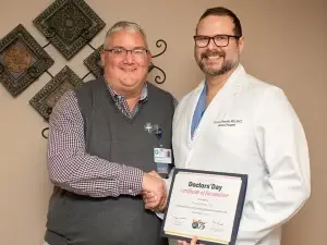 Dr. Kevin Kraeling congratulates Dr. Victor Pilewski on his PAMED award.