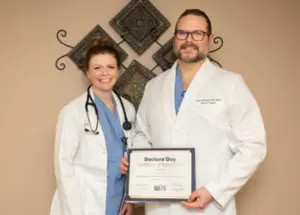 Dr. Victor Pilewski MD, FACS with Colleague on Doctors' Day with his certificate of recognition.