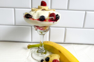 A dish of yogurt and various fruits comprises this breakfast parfait