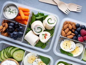 Bento box lunch with pinwheel wraps and other nutritious foods