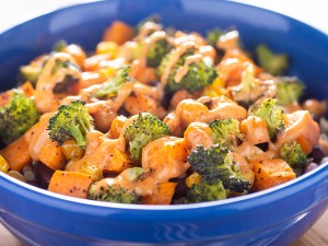 Salmon, broccoli, and sweet potatoes served in a bowl