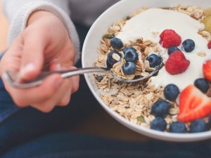 Woman eating oatmeal with berries