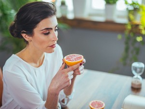 Woman eating grapefruit