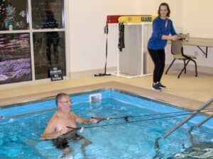 Physical therapists Mark and Stacey demonstrate one aspect of aquatic therapy.