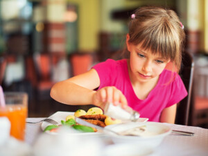 A girl added salt to her meal