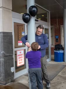 John and Hayden tying a balloon at Grove Street