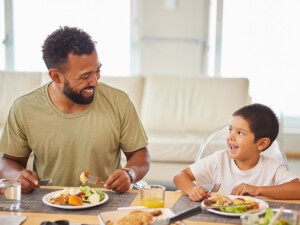 Father and son eating at dinner table