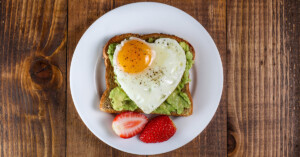 A heart shaped egg with avocado